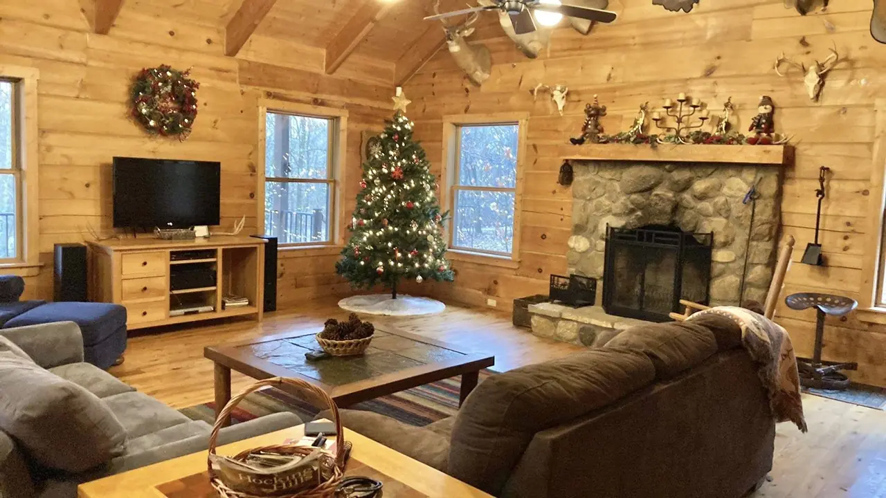 Great room decorated for Christmas with a tree and wreath